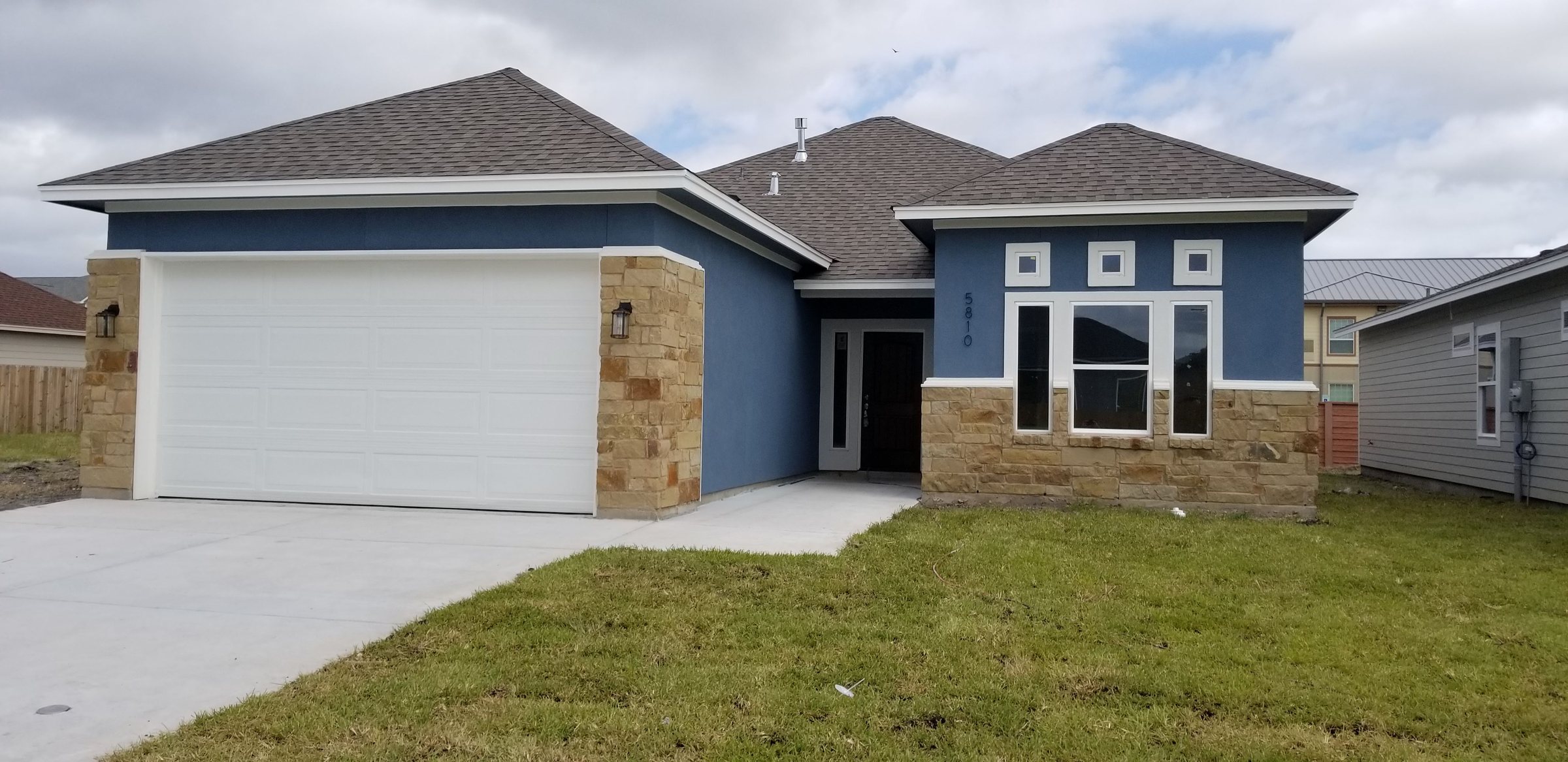 A single-family rental home with a stone front