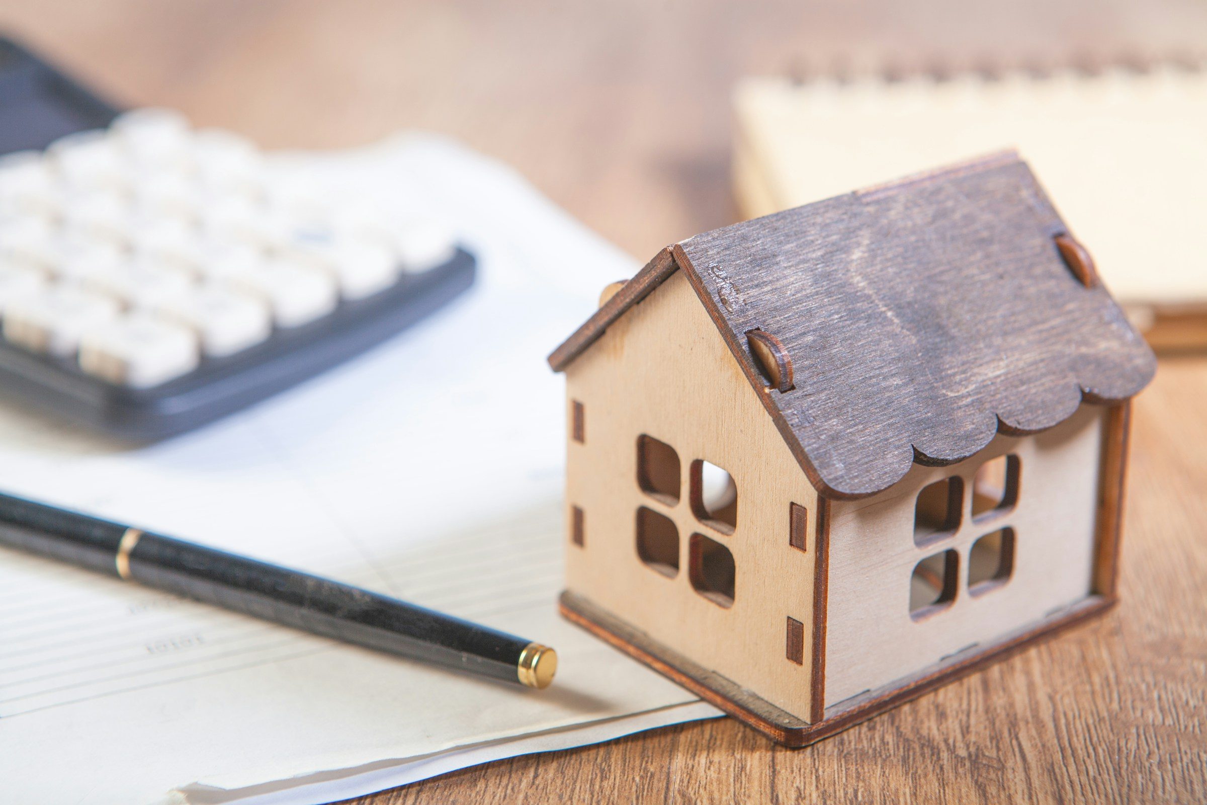 A model house, a calculator and notes